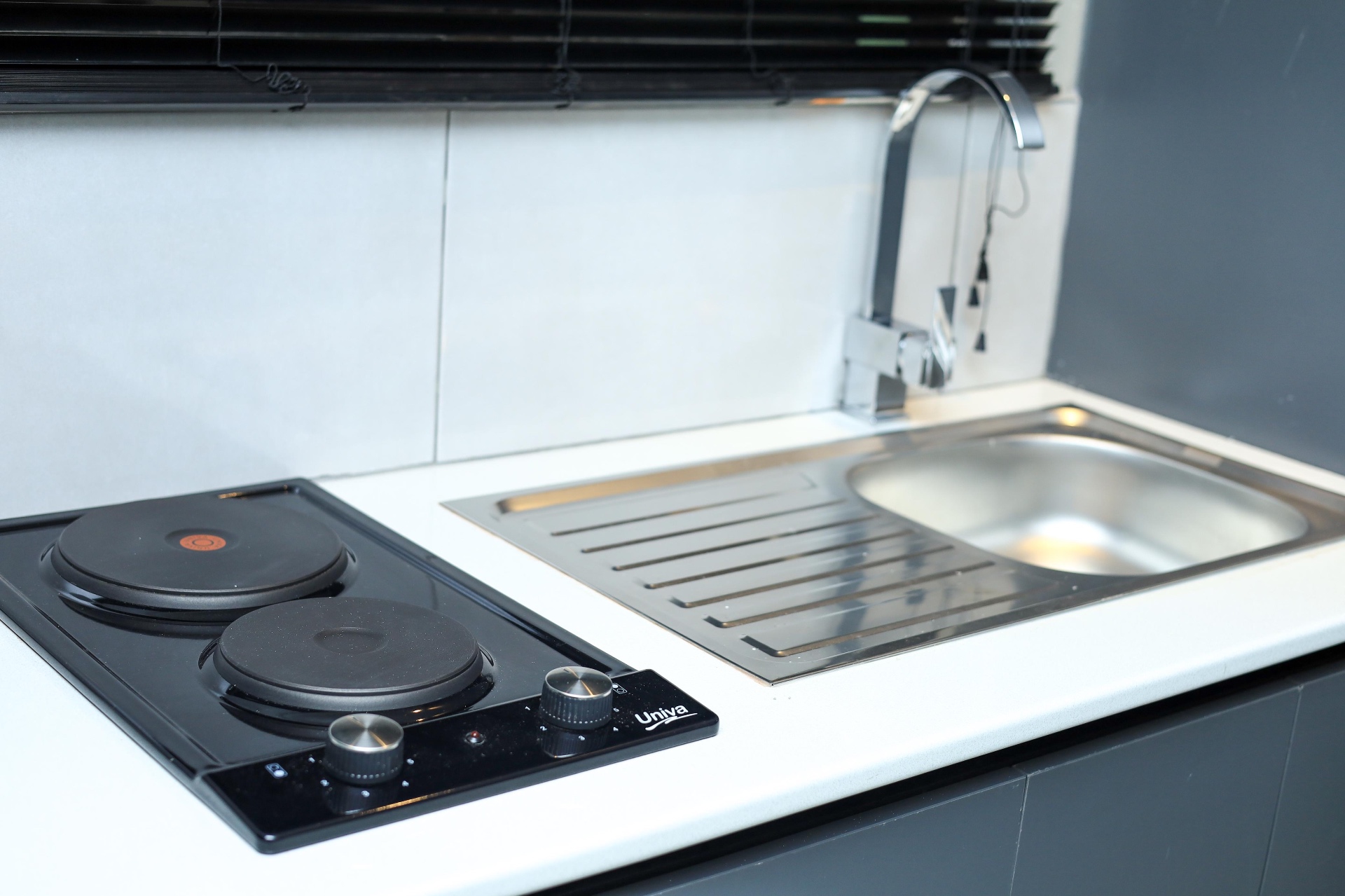 Shared kitchenette hob and sink at Mziyako Residence