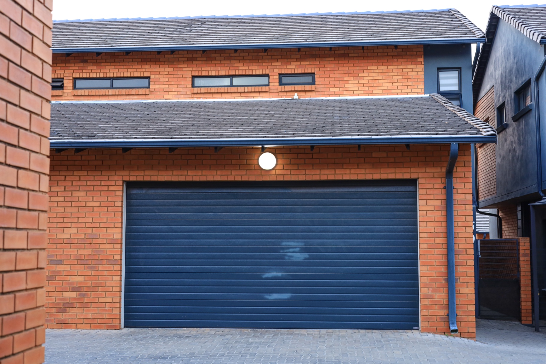 Double garage exterior with brick façade