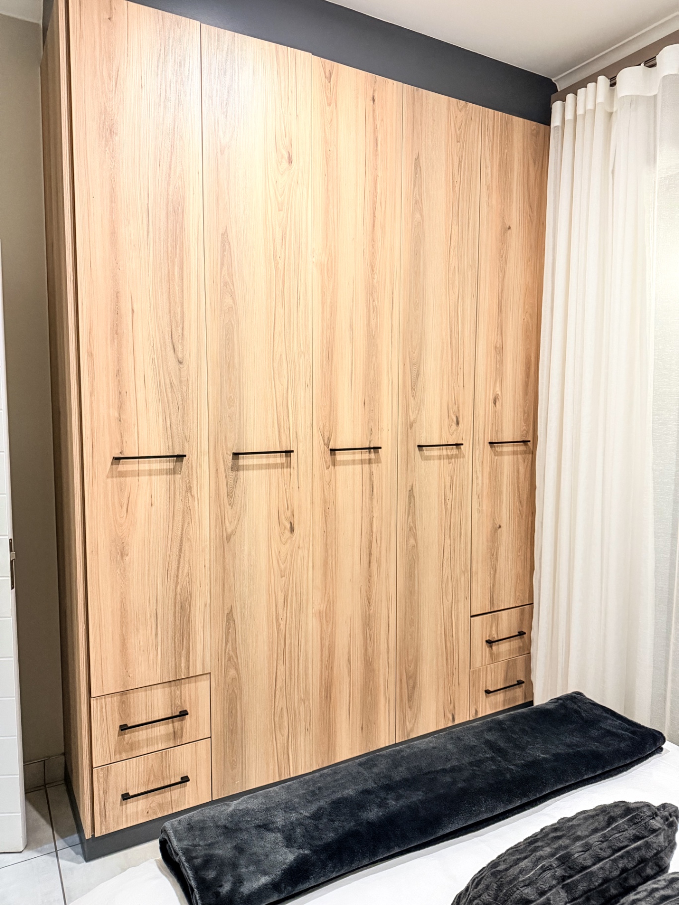 Full-height built-in bedroom wardrobes in oak